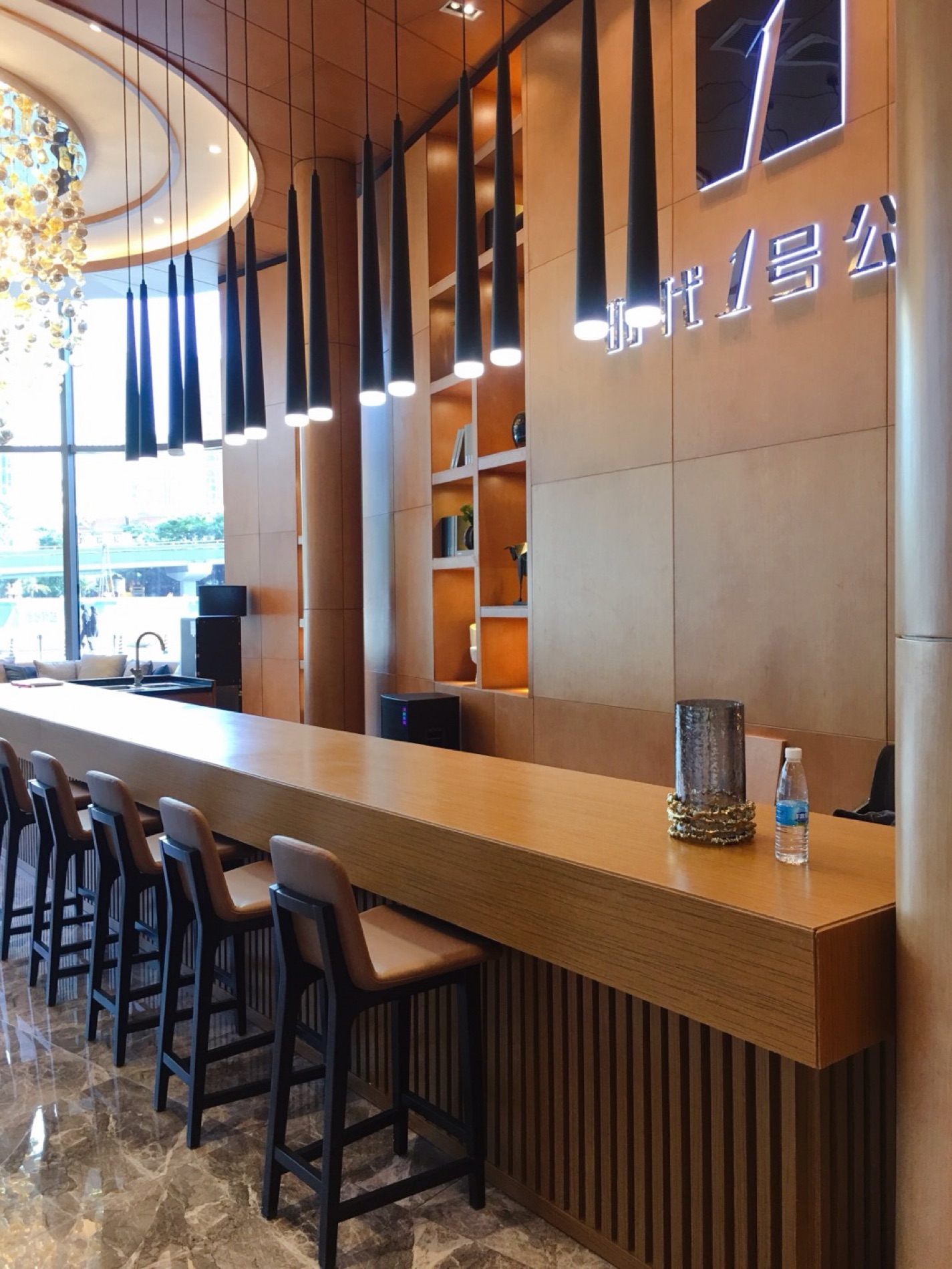 Metal screen and timber veneer wall in a sales centre lobby