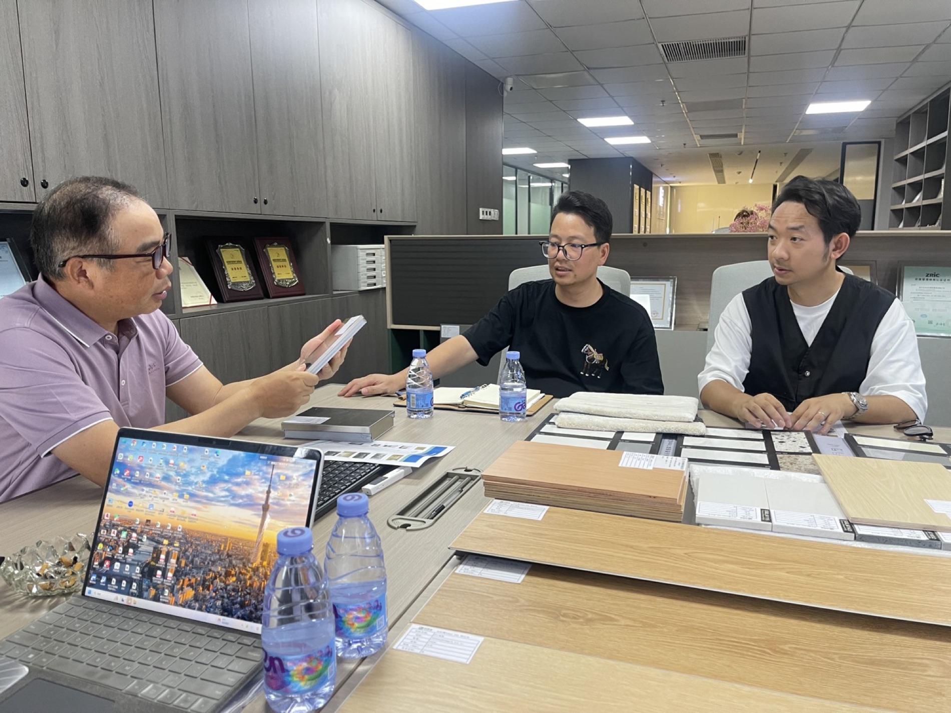 Client design review meeting with drawings and renders on screen